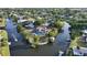 Waterfront home with lush landscaping, boat dock, private pool, and tile roof at 5500 Merrimac Dr, Sarasota, FL 34231
