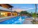 Spacious backyard with a refreshing pool and spa, complemented by lush landscaping and an inviting outdoor ambiance at 5500 Merrimac Dr, Sarasota, FL 34231
