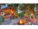 Inviting backyard fire pit area with a unique tiki-themed bar, creating a fun and relaxing outdoor entertainment space at 5500 Merrimac Dr, Sarasota, FL 34231