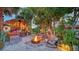 Cozy backyard fire pit with comfortable seating and a charming tiki bar area, perfect for relaxed outdoor evenings at 5500 Merrimac Dr, Sarasota, FL 34231