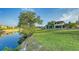 Gorgeous backyard featuring an expansive lawn, waterside seating and mature trees all overlooking a tranquil canal at 5500 Merrimac Dr, Sarasota, FL 34231