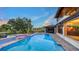 Gorgeous backyard showcasing a pristine pool with a spa, complemented by lush landscaping and inviting outdoor spaces at 5500 Merrimac Dr, Sarasota, FL 34231