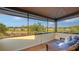 Screened in balcony with outdoor seating overlooking a serene waterfront view at 5500 Merrimac Dr, Sarasota, FL 34231