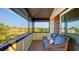 Relaxing screened balcony with seating and water view at 5500 Merrimac Dr, Sarasota, FL 34231
