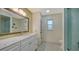 Bright bathroom with updated vanity, framed mirror, and tile shower featuring decorative fish decals at 5500 Merrimac Dr, Sarasota, FL 34231