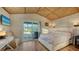 Bedroom featuring woven ceiling, sliding glass door to balcony, and hardwood floors at 5500 Merrimac Dr, Sarasota, FL 34231