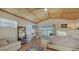 Bedroom with woven ceiling, sliding glass door to balcony, and desk setup at 5500 Merrimac Dr, Sarasota, FL 34231