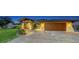 Inviting home with a paver driveway, attached two car garage, and tropical landscaping at 5500 Merrimac Dr, Sarasota, FL 34231