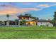 Charming two-story home featuring a lush green lawn and unique architectural details, perfect for serene suburban living at 5500 Merrimac Dr, Sarasota, FL 34231