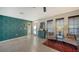 Bright foyer featuring an accent wall, tiled floors, and a decorative cabinet and mirror set at 5500 Merrimac Dr, Sarasota, FL 34231