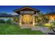 The front entrance with tropical landscaping and outdoor lighting at 5500 Merrimac Dr, Sarasota, FL 34231