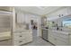 Charming kitchen with stainless steel appliances, and lots of storage in custom cabinets at 5500 Merrimac Dr, Sarasota, FL 34231