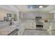 Well-equipped kitchen with custom cabinets, stainless appliances, marble countertops and backsplash at 5500 Merrimac Dr, Sarasota, FL 34231