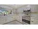 Bright kitchen with Viking stainless steel appliances, custom cabinets, and white marble countertops at 5500 Merrimac Dr, Sarasota, FL 34231