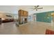 Spacious living room with a unique brick fireplace, tiled floors, and ample living space at 5500 Merrimac Dr, Sarasota, FL 34231