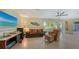 Inviting living room with a large window, comfortable seating, and an entertainment area at 5500 Merrimac Dr, Sarasota, FL 34231