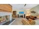 Comfortable living room with a unique fireplace, entertainment system, and views to the yard at 5500 Merrimac Dr, Sarasota, FL 34231