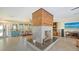 Well-lit living room with a modern fireplace, stylish decor, and tile flooring at 5500 Merrimac Dr, Sarasota, FL 34231
