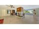 Spacious living room with a unique fireplace and large windows offering a view of the backyard at 5500 Merrimac Dr, Sarasota, FL 34231