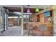 Outdoor bar area featuring bar-style seating, grill, decorative lighting, and TV at 5500 Merrimac Dr, Sarasota, FL 34231