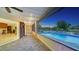 Covered patio with pool view, sliding glass doors to indoor living spaces at 5500 Merrimac Dr, Sarasota, FL 34231