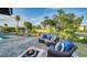 Spacious backyard patio with seating area, fire pit, and picturesque canal views at 5500 Merrimac Dr, Sarasota, FL 34231