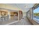 Screened patio with sliding glass doors to the living area and view of the pool at 5500 Merrimac Dr, Sarasota, FL 34231