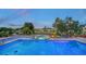 Beautiful pool and jacuzzi overlooking the canal with outdoor seating and meticulous landscaping at 5500 Merrimac Dr, Sarasota, FL 34231