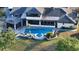 Aerial shot of the pool and spa; the perfect setting for outdoor relaxation and entertaining, surrounded by mature landscaping at 5500 Merrimac Dr, Sarasota, FL 34231