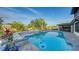Relaxing pool area featuring a sparkling pool, spa, and serene views of the surrounding landscape and patio at 5500 Merrimac Dr, Sarasota, FL 34231