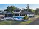 Expansive backyard featuring a stunning pool, jacuzzi, and lush tropical landscaping offering a private retreat at 5500 Merrimac Dr, Sarasota, FL 34231