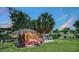 An inviting Tiki Hut with tropical decor, lush landscaping, and waterfront views at 5500 Merrimac Dr, Sarasota, FL 34231