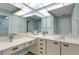 Bright bathroom with a vanity area, dual sinks, and plenty of storage at 5626 Pipers Waite # 22, Sarasota, FL 34235