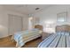 Charming bedroom features twin beds, wood floors and closet with bi-fold doors at 5626 Pipers Waite # 22, Sarasota, FL 34235