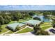 Aerial view of the community center, showcasing lush landscaping, mature trees, and ample parking at 5626 Pipers Waite # 22, Sarasota, FL 34235