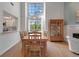 Bright dining room features a large window, chandelier, and wood table with seating for six at 5626 Pipers Waite # 22, Sarasota, FL 34235