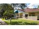 Charming building exterior featuring lush landscaping and a blue awning that enhances the curb appeal at 5626 Pipers Waite # 22, Sarasota, FL 34235