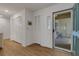 Bright foyer with wood floors, closet space and a storm door offering a glimpse of the outdoor patio at 5626 Pipers Waite # 22, Sarasota, FL 34235