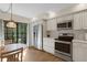 Well-lit kitchen with stainless steel appliances, white cabinets, and breakfast nook, perfect for casual dining at 5626 Pipers Waite # 22, Sarasota, FL 34235