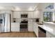 Modern kitchen with stainless steel appliances, white cabinets, and stylish backsplash for a clean look at 5626 Pipers Waite # 22, Sarasota, FL 34235