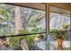 A cozy outdoor lanai with seating offers views of the pond at 5626 Pipers Waite # 22, Sarasota, FL 34235