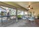 Relaxing screened lanai with comfortable seating area and outdoor ceiling fan at 5626 Pipers Waite # 22, Sarasota, FL 34235