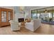 Cozy living room featuring a fireplace and a sliding glass door leading to the outdoor patio at 5626 Pipers Waite # 22, Sarasota, FL 34235