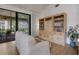Living room featuring a sliding glass door leading to a screened-in patio at 5626 Pipers Waite # 22, Sarasota, FL 34235