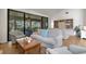 Living room featuring sliding glass doors leading to a screened-in patio with outdoor seating at 5626 Pipers Waite # 22, Sarasota, FL 34235