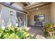 Inviting patio space with seating area and view through sliding glass door entrance with ample light at 5626 Pipers Waite # 22, Sarasota, FL 34235