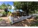Exterior view of the Phoenix Village Pub showing a white picket fence and outdoor patio seating area at 5626 Pipers Waite # 22, Sarasota, FL 34235