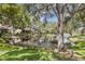 Lush landscaping surrounds a tranquil pond next to the homes at 5626 Pipers Waite # 22, Sarasota, FL 34235