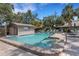 Community pool with well-maintained brick surround, inviting seating, and accessible steps at 5626 Pipers Waite # 22, Sarasota, FL 34235