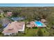 Aerial view of the property featuring a tennis court and a sparkling blue community pool at 5712 Garden Lakes Dr, Bradenton, FL 34203
